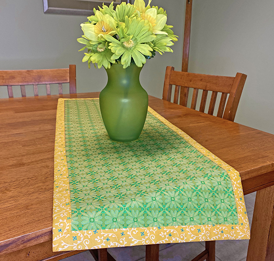 Learn How to Make a No-Hassle Table Topper Table Runner with Mitered Corners with our No-Hassle Table Topper Sewing Tutorial at The Nancy Zieman Productions Blog