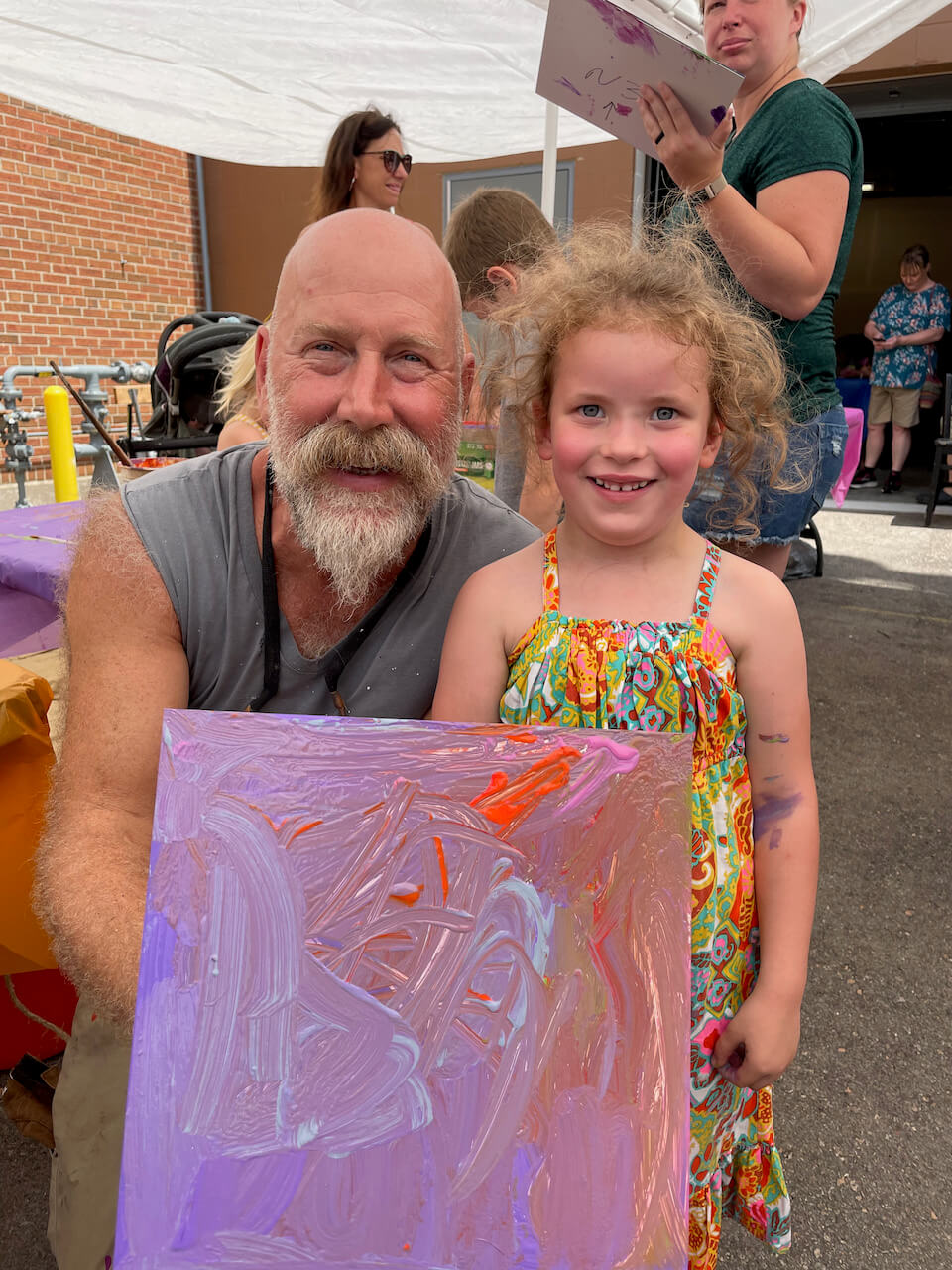 Artist Steven Bennet and Poppy Shier Painting Mosaic Tiles at the First Annual Arts and Peony Festival in Beaver Dam Wisconsin for the Nancy Zieman Mosaic Mural